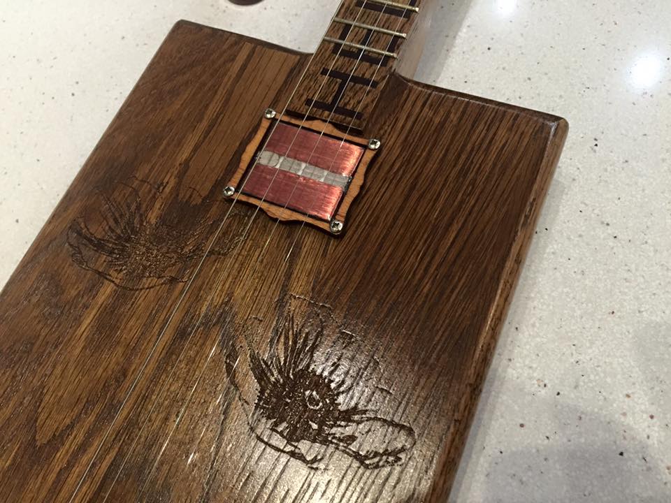 Laser engraved cigar box guitar photo